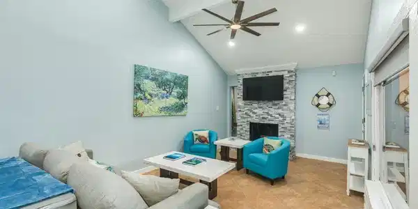 Image 4: LR:  Fireplace with beautiful tile, ceiling fan, a