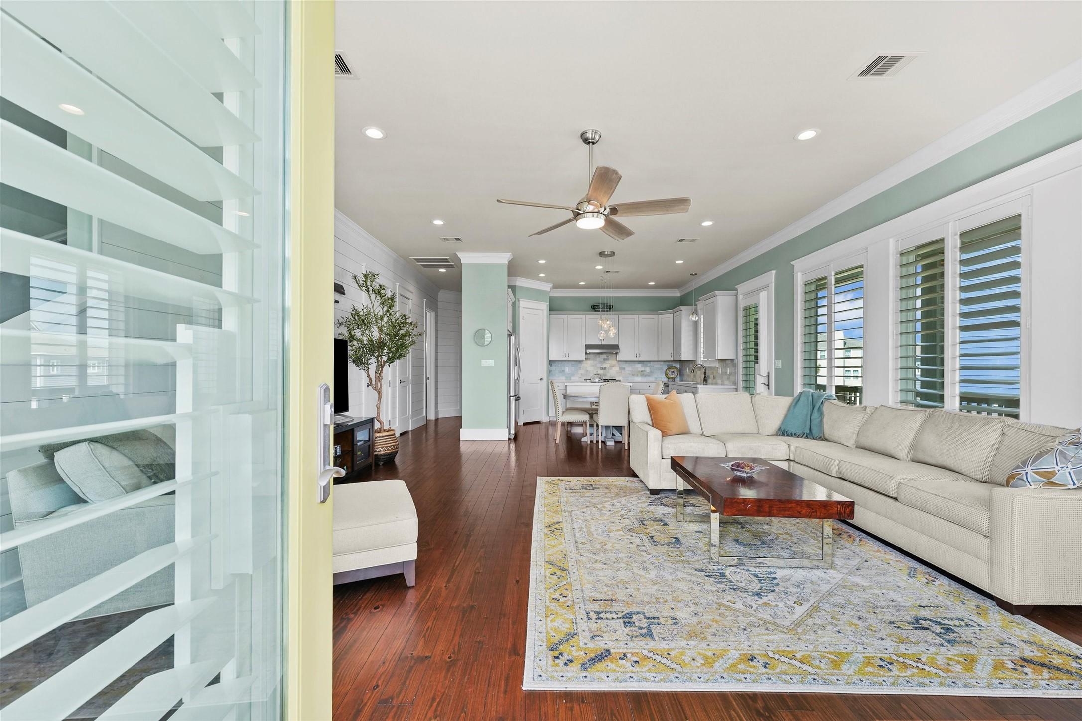 Image 4: The open-concept living room is bathed in natural