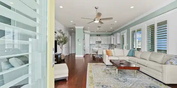 Image 4: The open-concept living room is bathed in natural