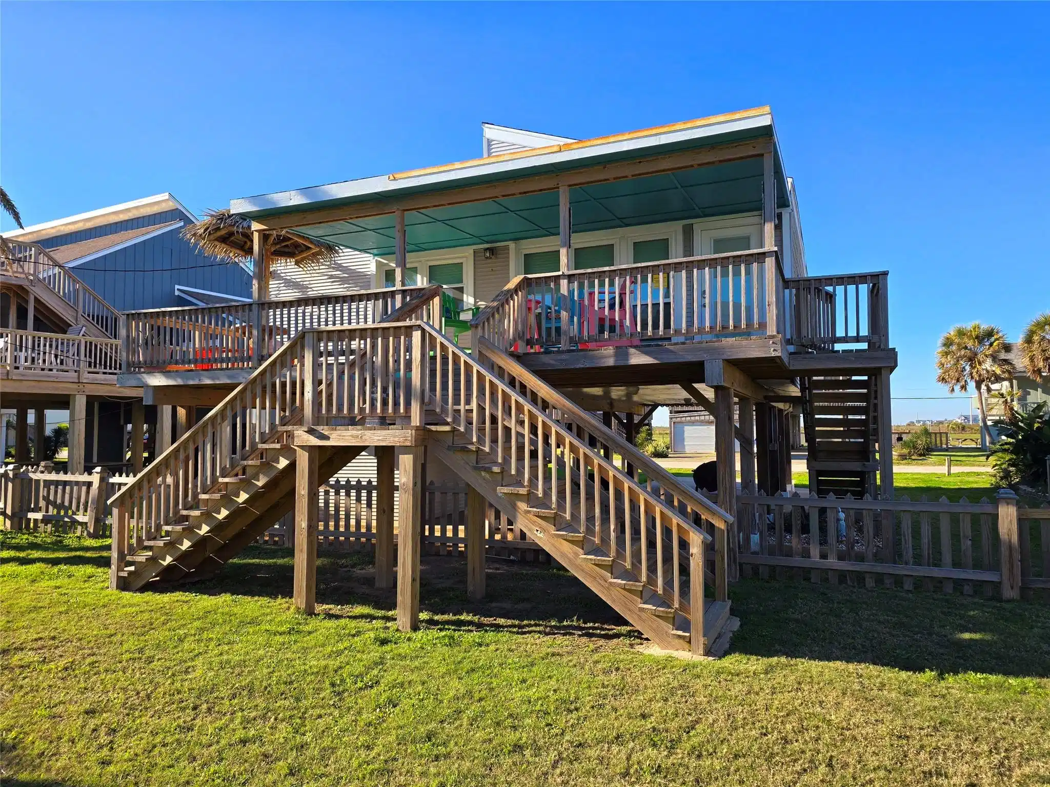 Image 1: This is a charming beach house with a spacious woo