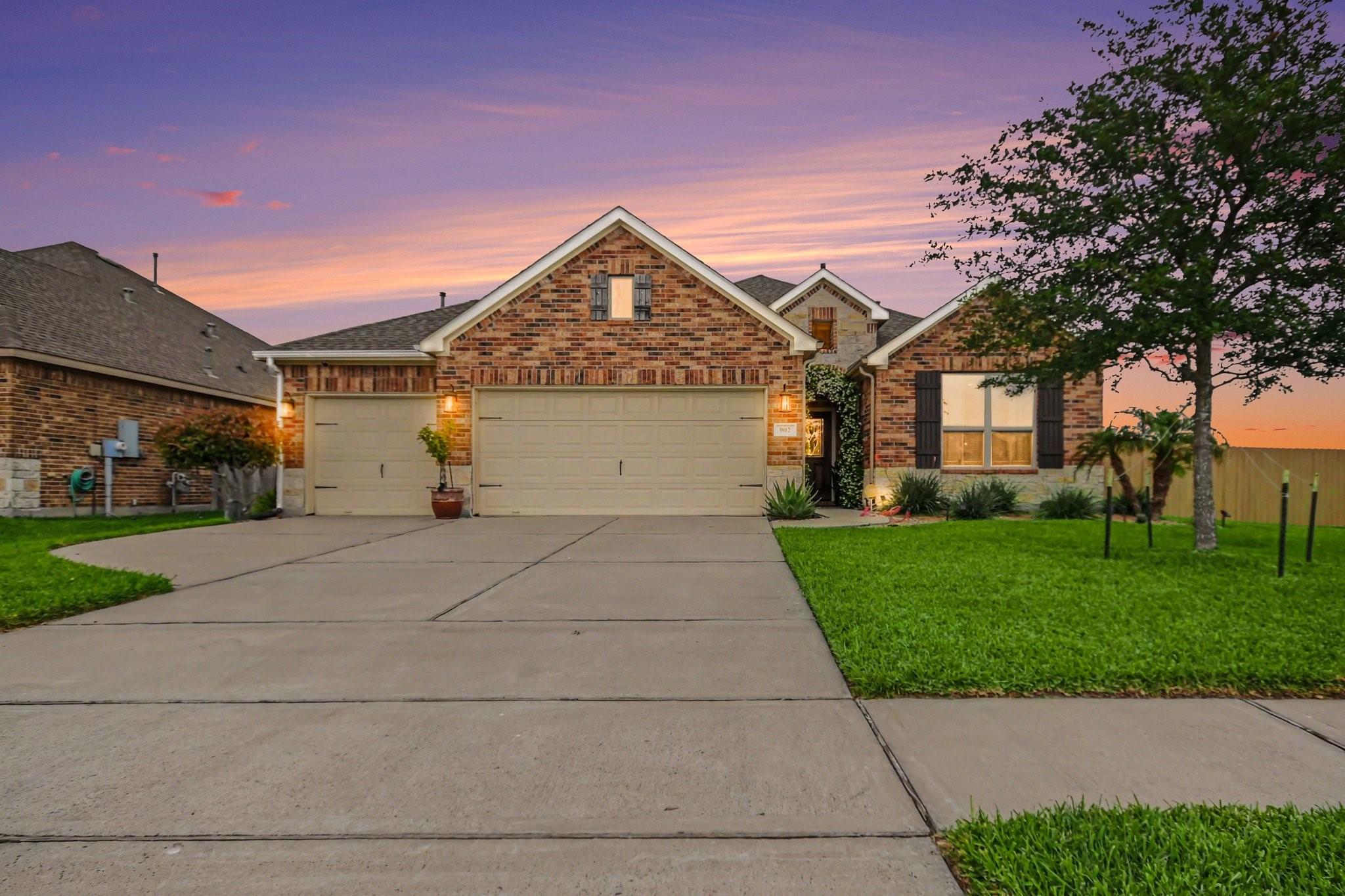 Image 1: This charming single-story brick home features a w