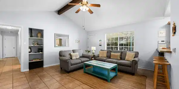 Image 4: Spacious family room with a vaulted ceiling, expos