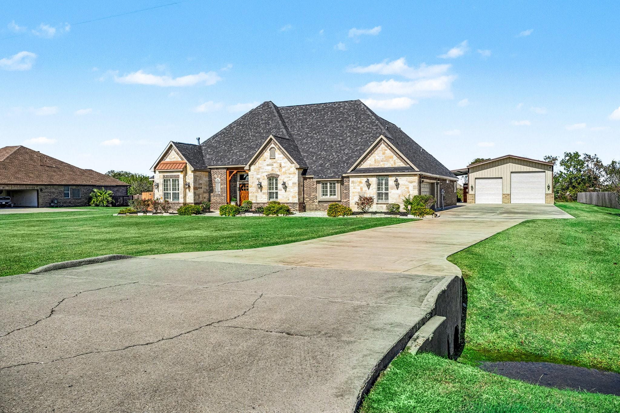 Image 3: View of home with double wide driveway to 2-car ga
