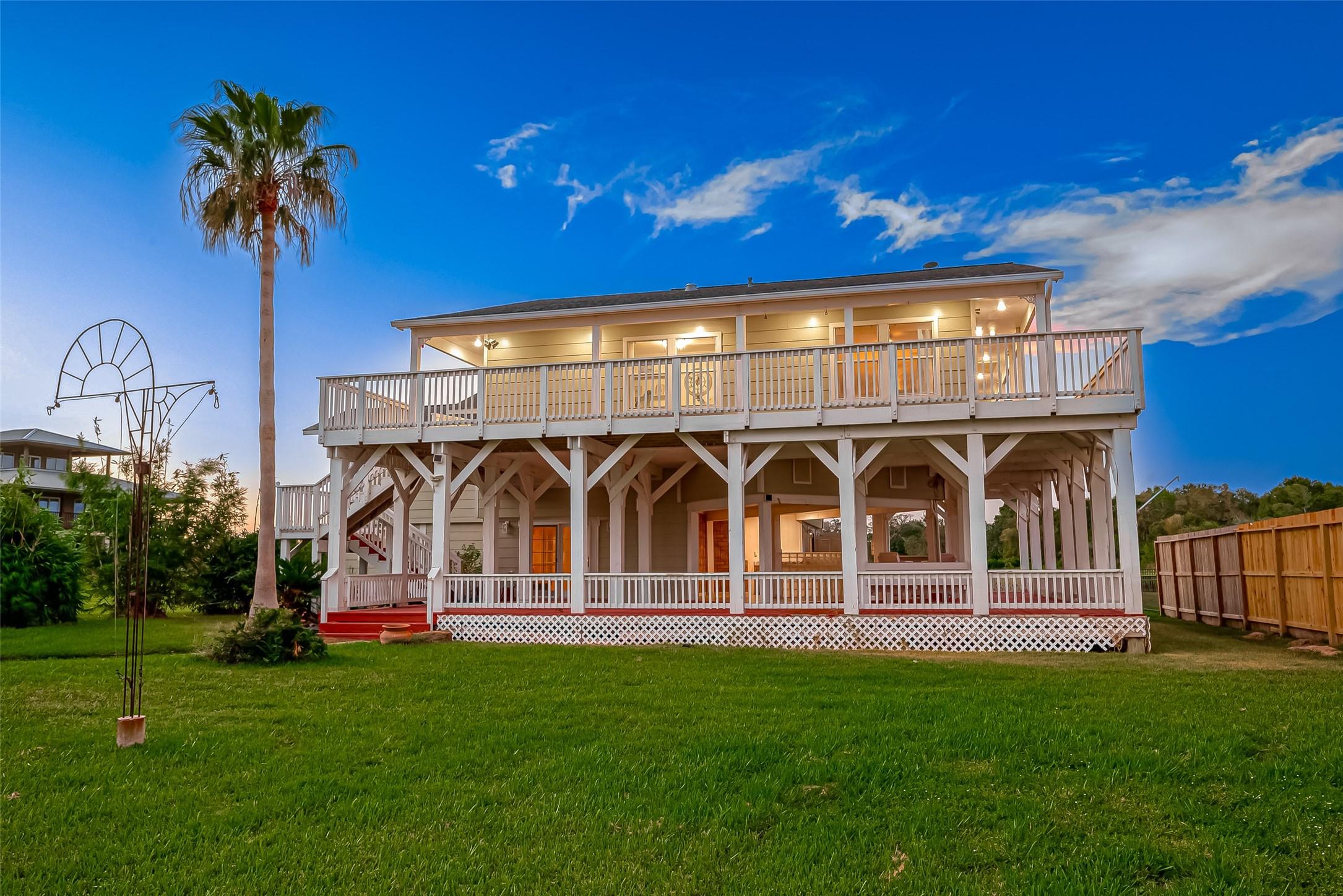 Image 1: Striking coastal-style home with expansive wraparo