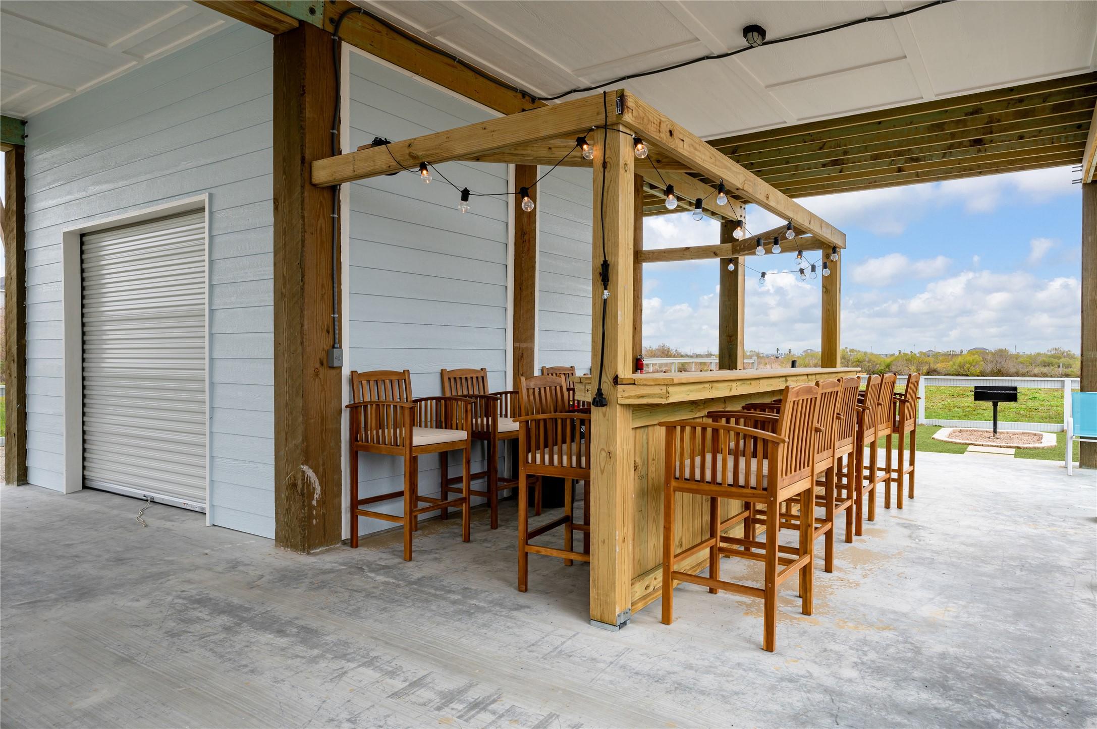 Image 4: The tiki bar is strung with lights and is ready fo