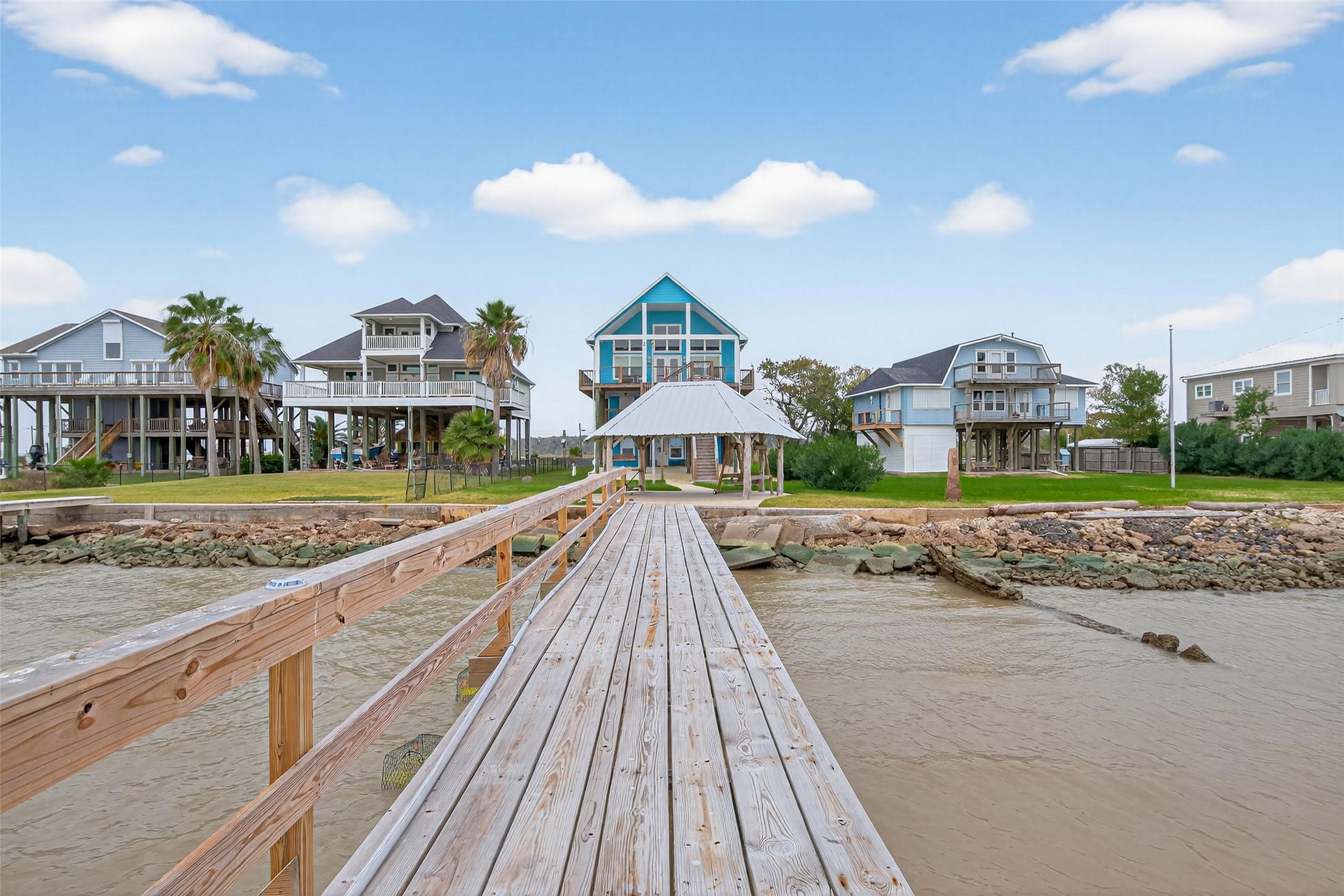 Image 3: This waterside property features a charming stilt