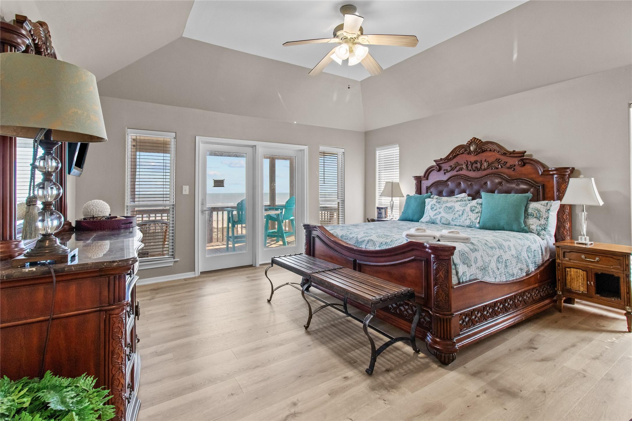 Image 1: This spacious bedroom features elegant wooden furn