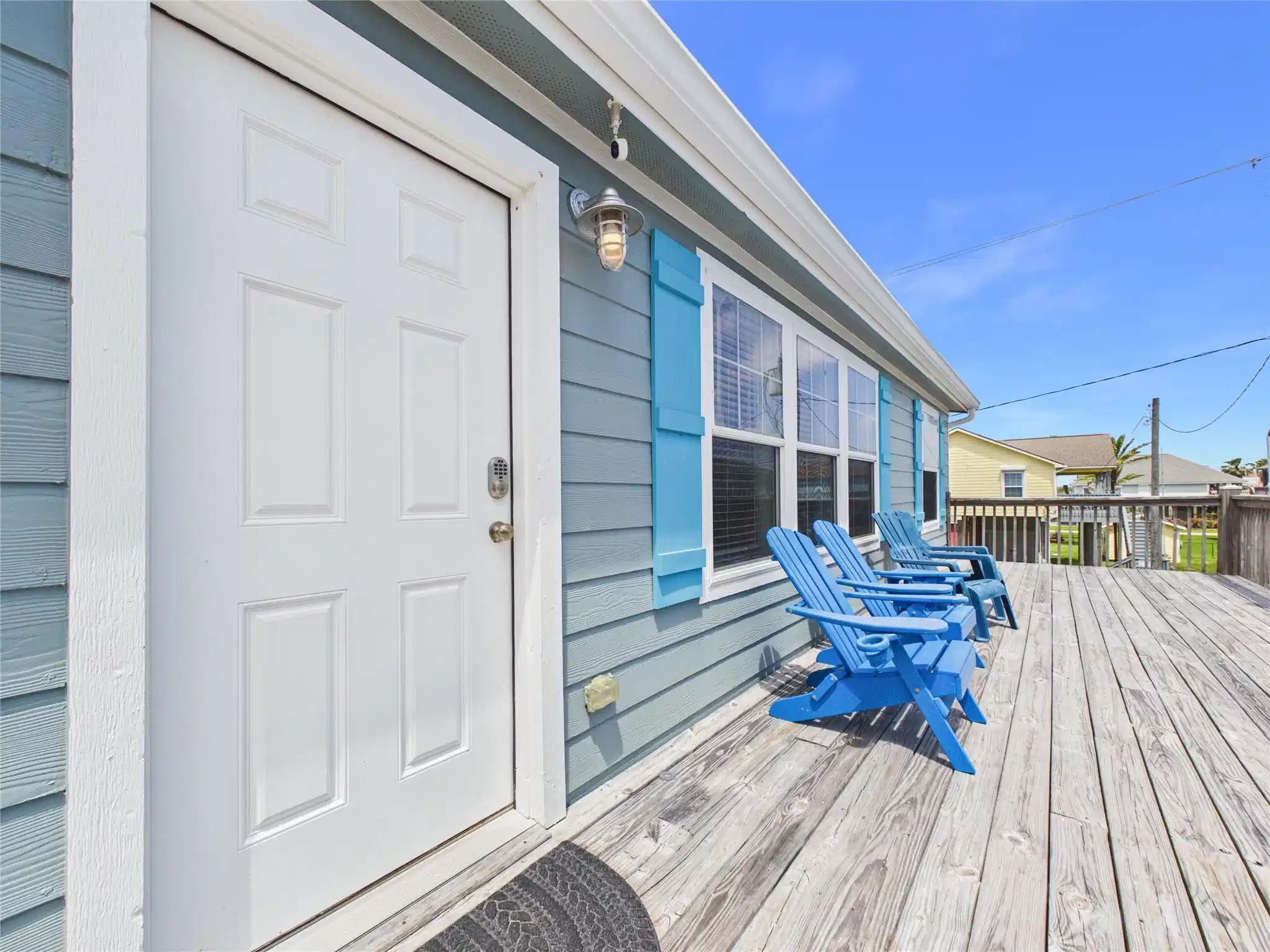 Image 1: This inviting home features a spacious wooden deck