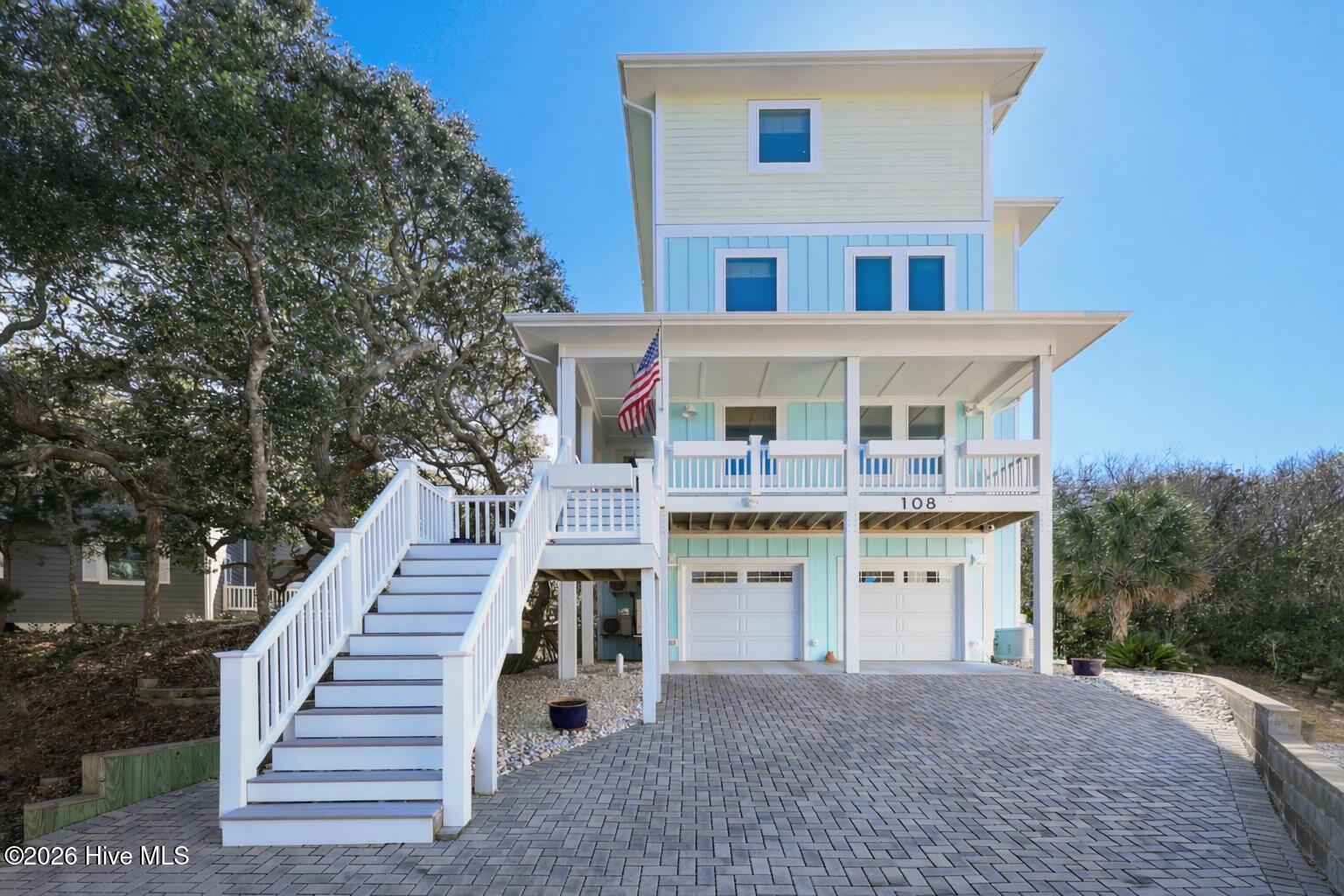 Image 1: Coastal house with American flag