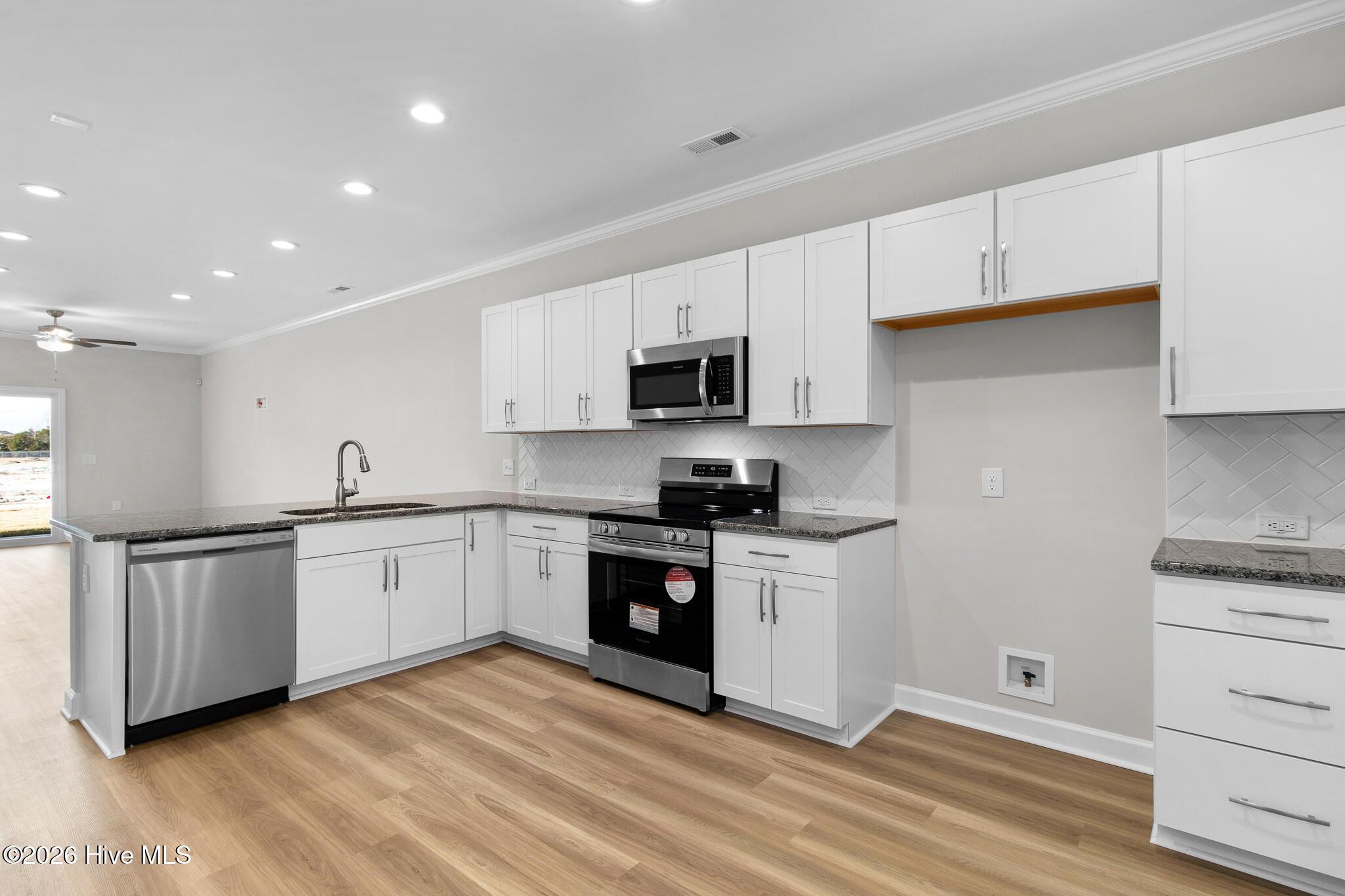 Image 3: Kitchen- Open Concept to Dining & Living