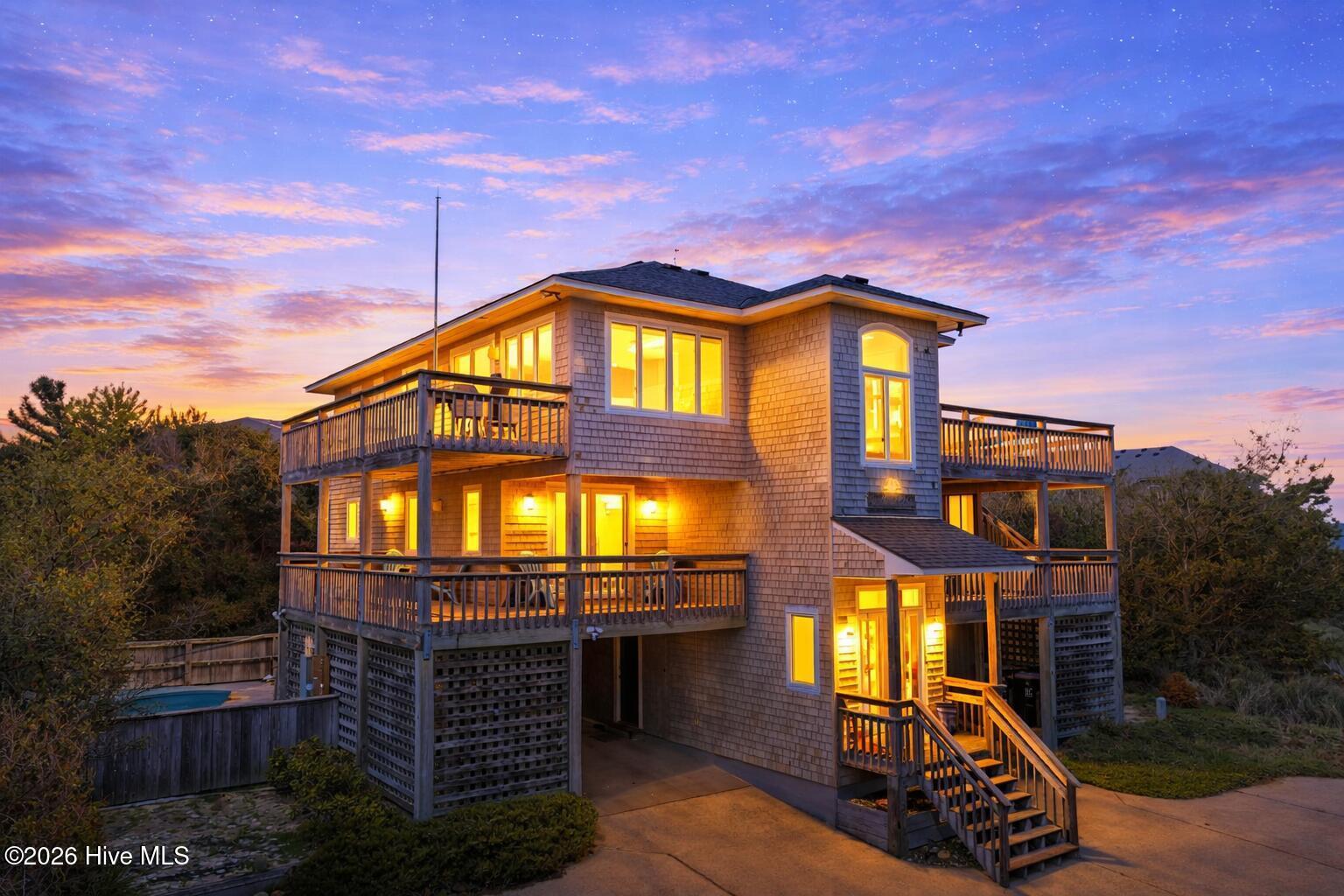 Image 3: Coastal beach house at dusk