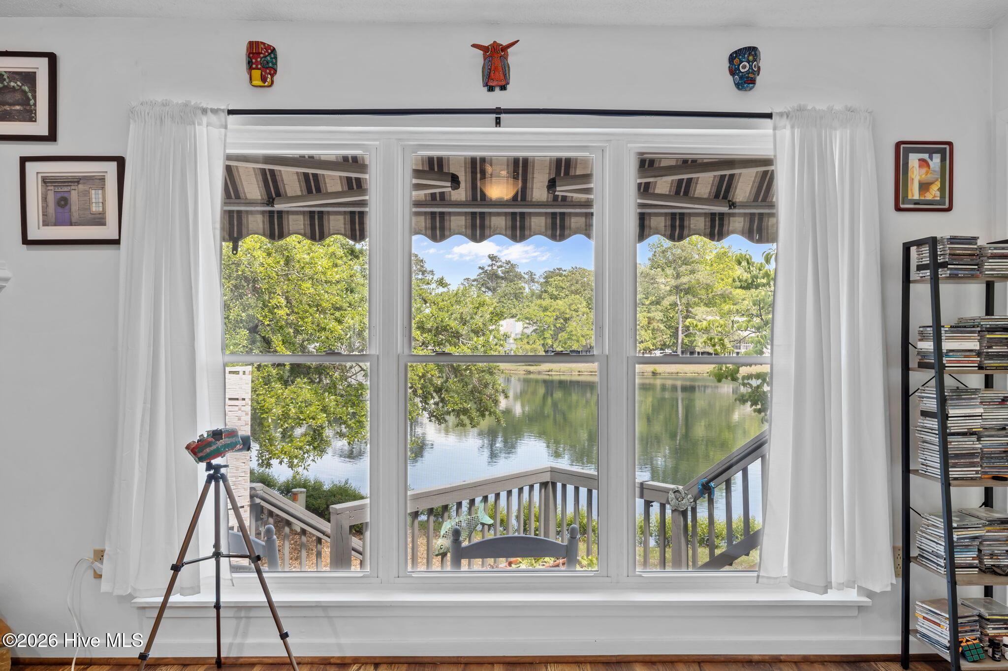 Image 3: Living area windows looking out to lake