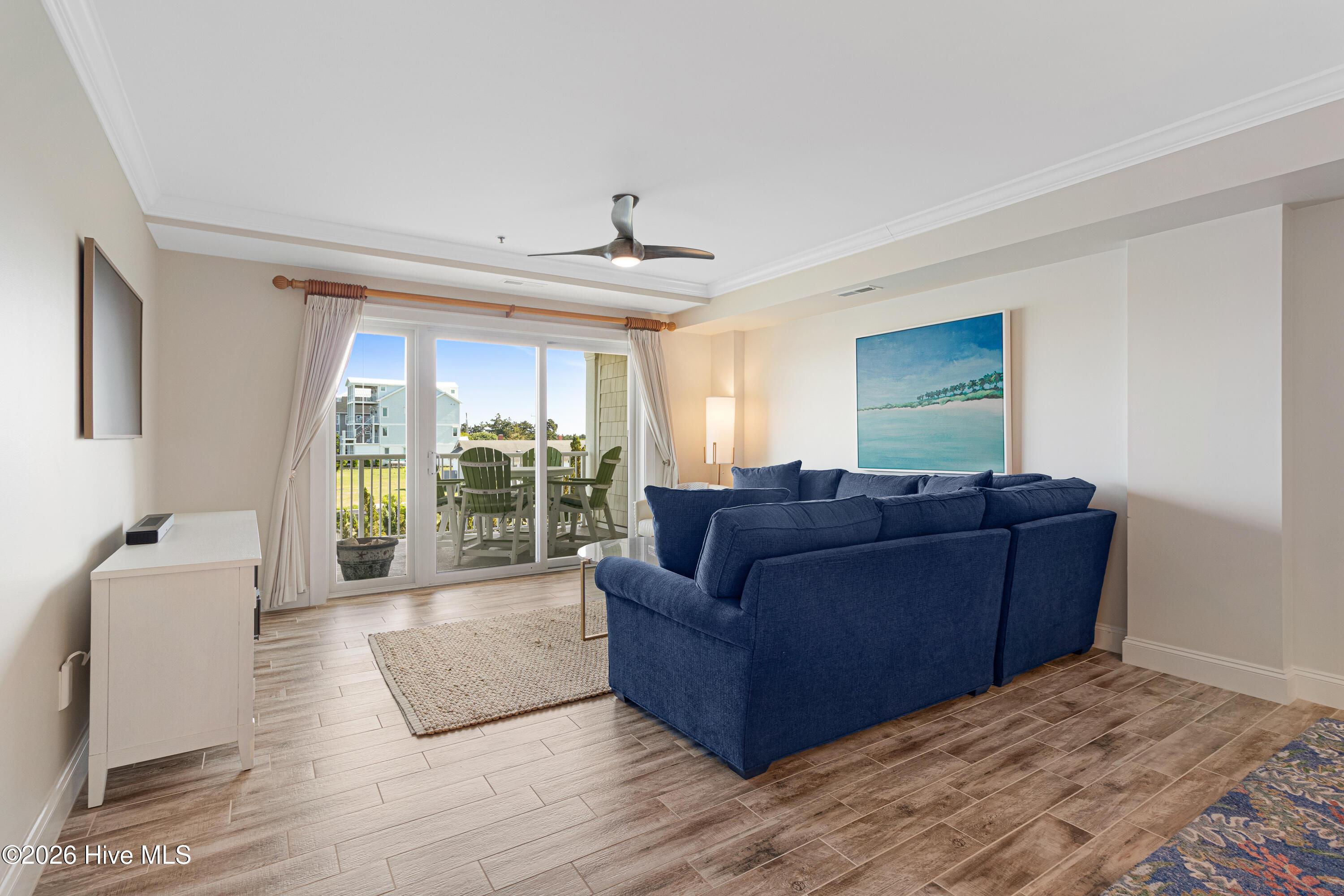 Image 3: Living room with covered balcony access