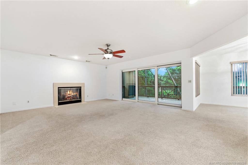 Image 4: Main level family room opens to a deck overlooking