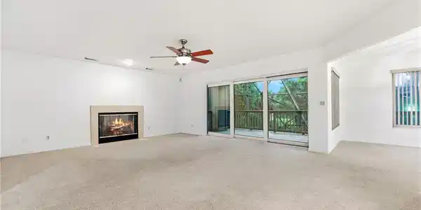 Image 4: Main level family room opens to a deck overlooking