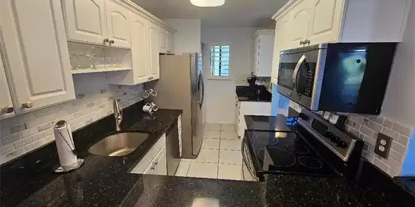 Image 2: KITCHEN HAS UPDATED CABINETS, GRANITE COUNTERTOPS.