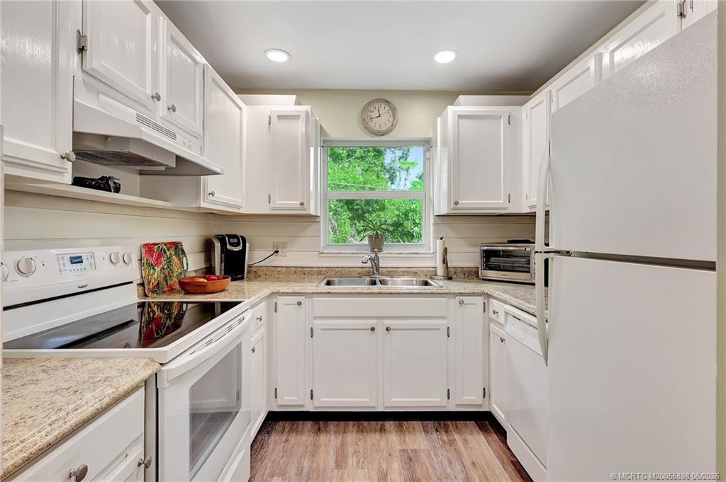 Image 2: Kitchen sink overlooks mature trees.