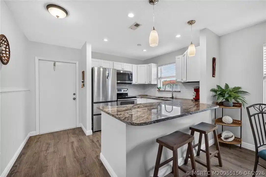 Image 1: Modern updated kitchen with recessed lighting.