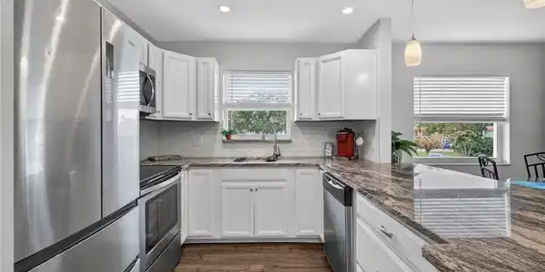Image 2: Granite countertops paired with stainless. applian