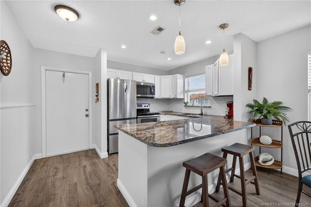 Image 1: Modern updated kitchen with recessed lighting.