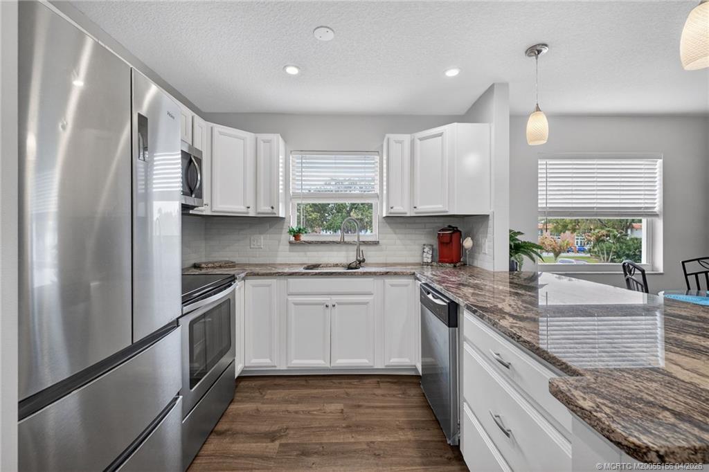 Image 2: Granite countertops paired with stainless. applian