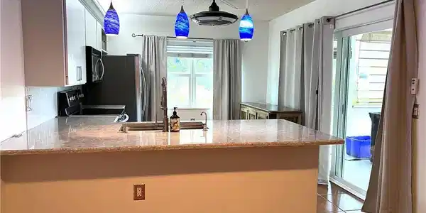 Image 4: Kitchen- Impact Sliders & Windows throughout.