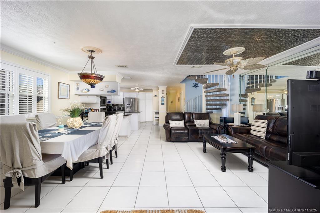 Image 4: Dining and family rooms flank kitchen for gatherin