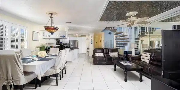 Image 4: Dining and family rooms flank kitchen for gatherin