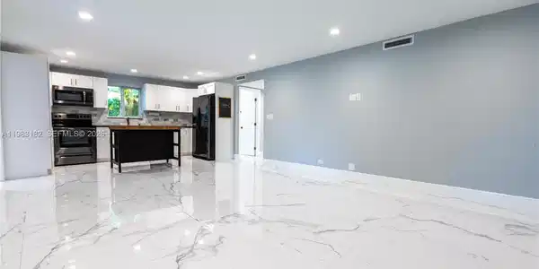 Image 2: Bright open kitchen, dining, and living area perfect for entertaining.