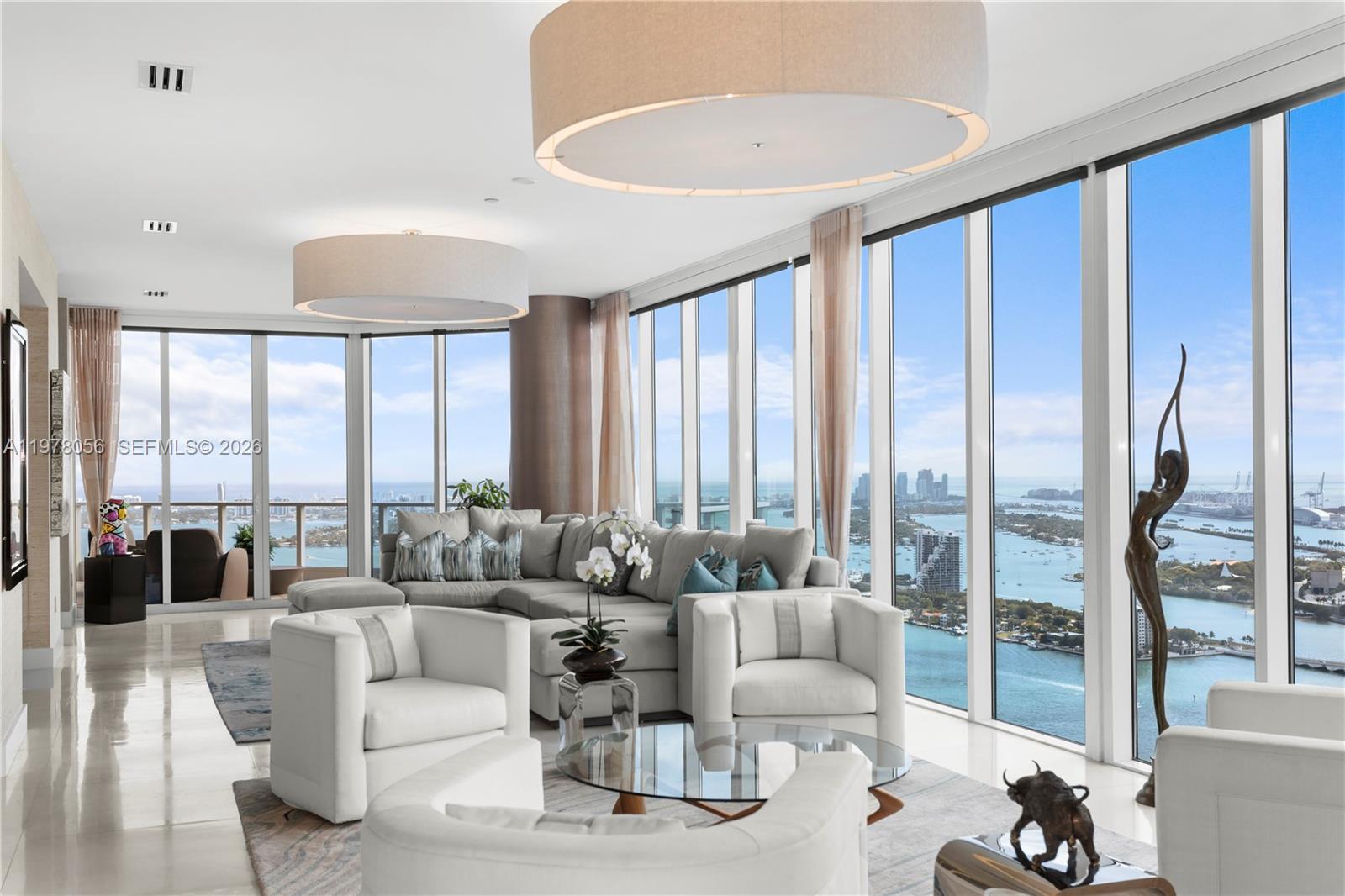 Image 1: Living area framed by floor-to-ceiling glass