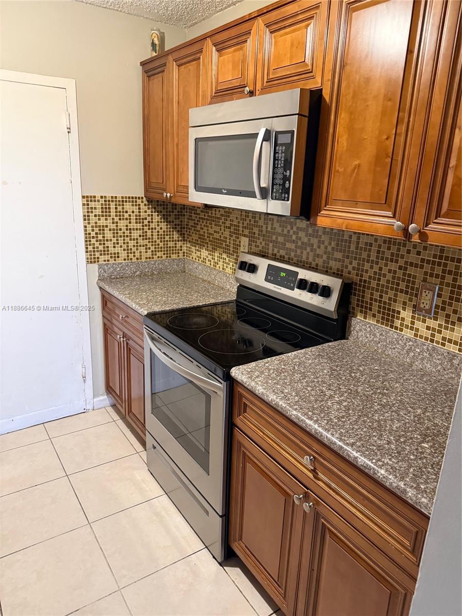 Image 2: Kitchen - Solid Counters & Tiled Floors