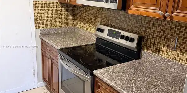 Image 2: Kitchen - Solid Counters & Tiled Floors