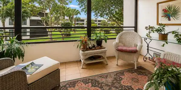 Image 2: The screened in lanai offers beautiful views over the peaceful landscaped gardens from the 2nd floor