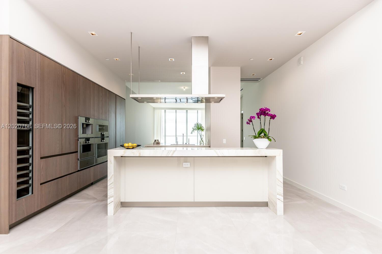 Image 4: Snaidero Italian custom cabinetry in kitchen, Italian stone countertops, and Best Gaggenau appliance