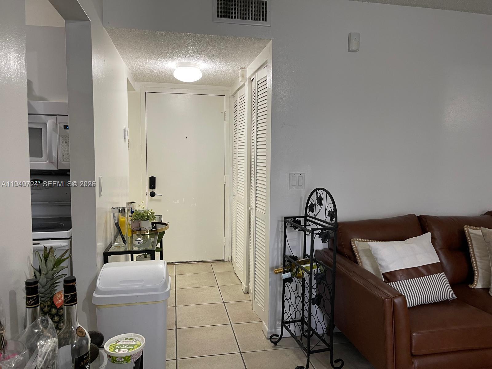 Image 2: Foyer leading to half bath, kitchen & LR