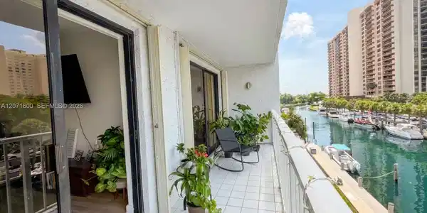 Image 4: Expansive private balcony with peaceful canal views, ideal for outdoor dining and relaxing.
