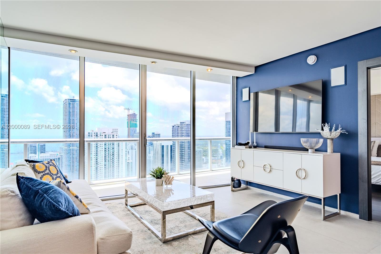 Image 3: Living room with ocean view, plenty of sunshine to make your heart dance.