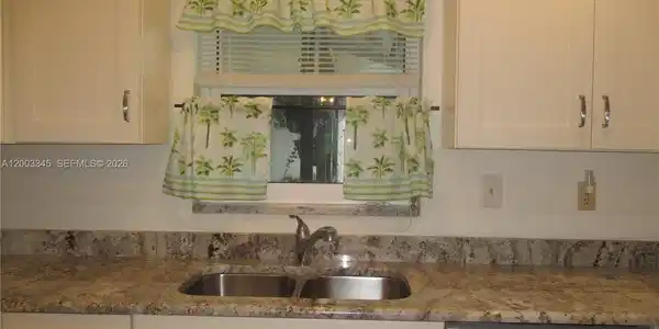 Image 2: Granite countertops/cream colored cabinets & dual sink