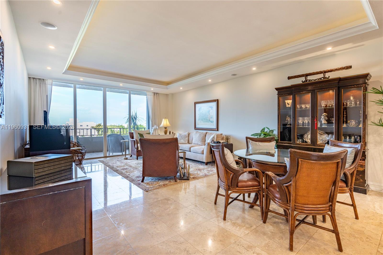 Image 3: A spacious, open-plan great room features a light cone that encircles the living and dining room are