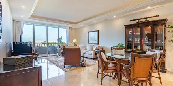 Image 3: A spacious, open-plan great room features a light cone that encircles the living and dining room are