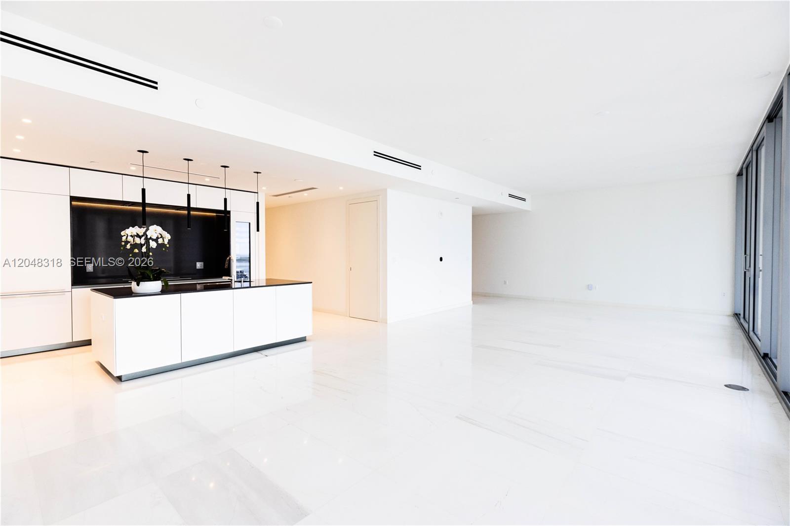 Image 1: Spacious Living/Dining - Custom Kitchen - an open chef&rsquo;s kitchen with custom Bulthaup cabinetr