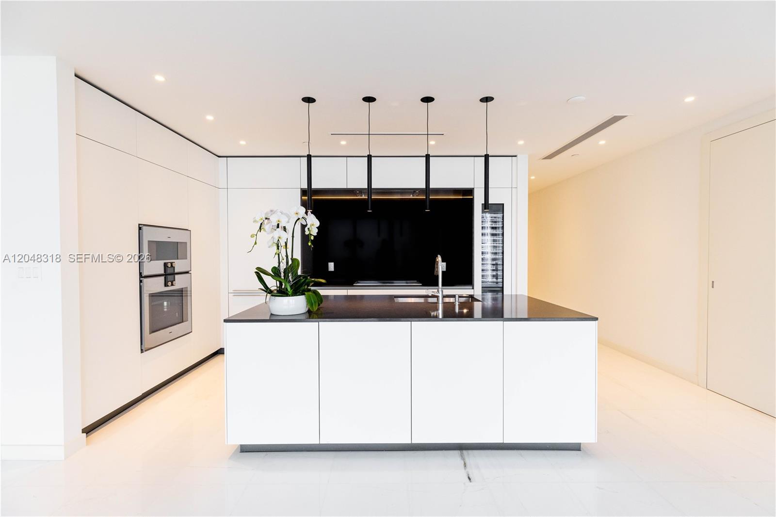 Image 2: an open chef&rsquo;s kitchen with custom Bulthaup cabinetry and top-of-the-line Gaggenau appliances 