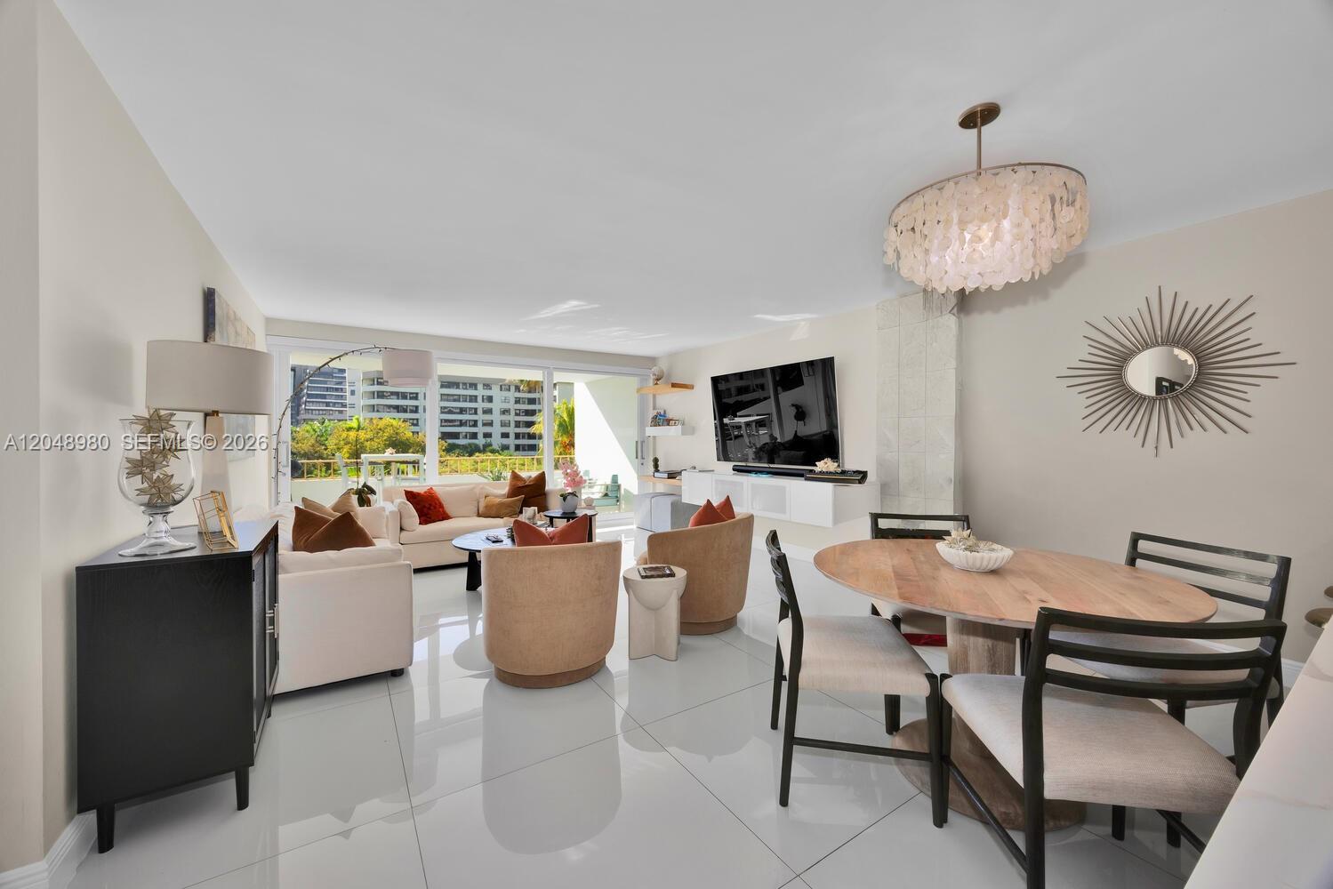 Image 4: Spacious living/dining area leading to a wide balcony!