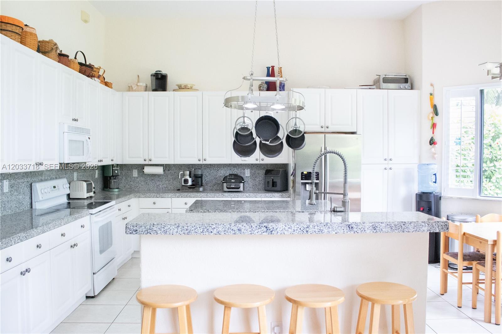 Image 3: Huge kitchen with high ceilings, center island, snack counter and breakfast table.