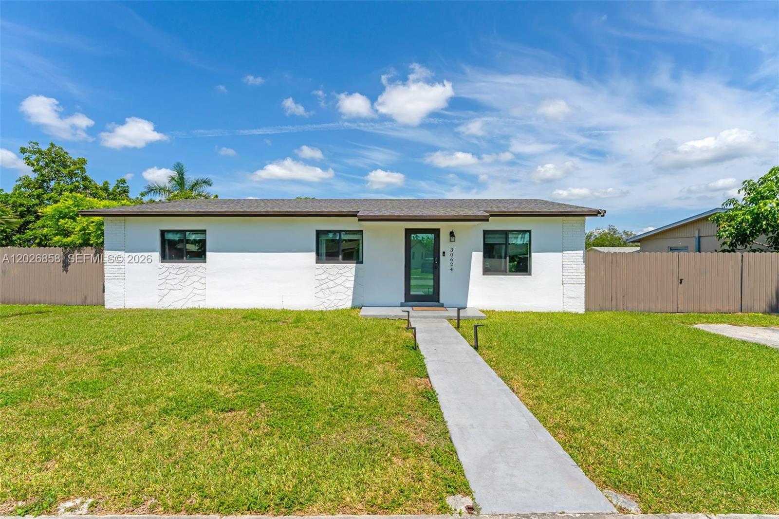 Image 1: Modern curb appeal with fresh exterior paint, updated windows, and a spacious front yard.