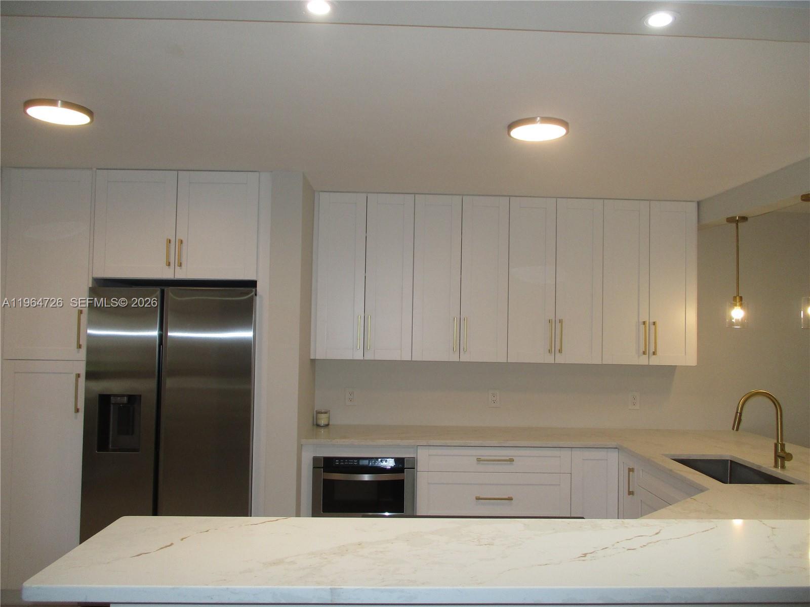 Image 2: QUARTZ COUNTERTOP WITH STAINLESS STEEL APPLIANCES & WHITE 42"CABINETS