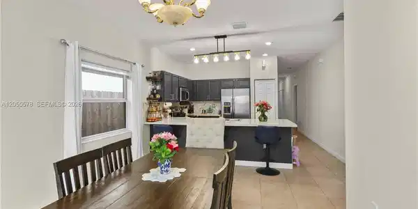 Image 3: Step into comfort! This inviting living area flows seamlessly from the entryway, creating an open an