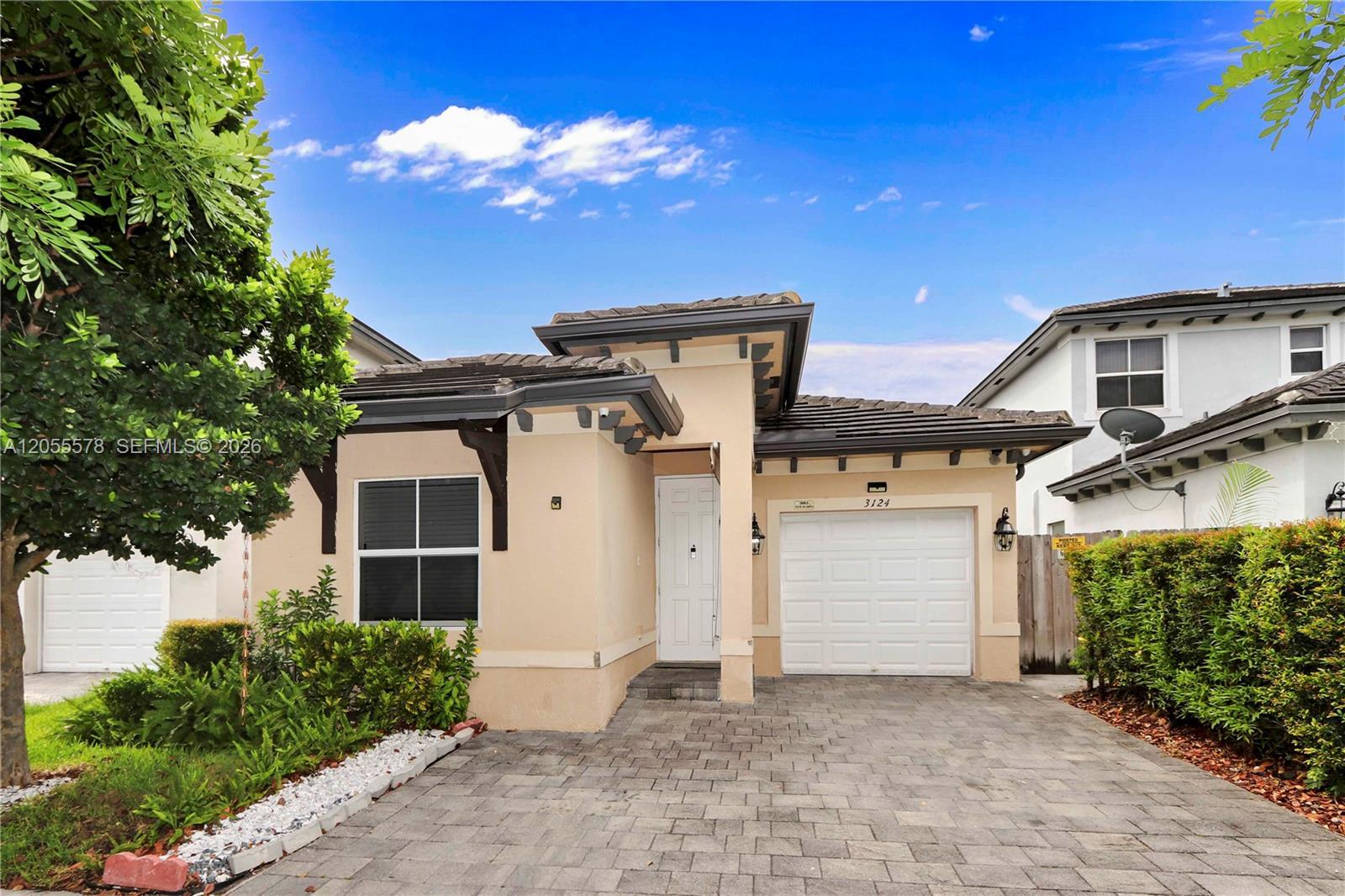 Image 1: Welcome home! Featuring a beautifully maintained exterior, this residence offers a clean, inviting e