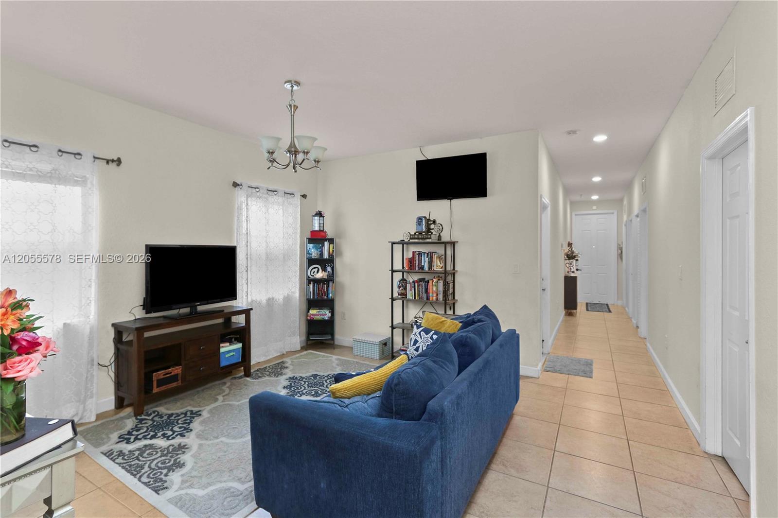Image 2: Step into comfort! This inviting living area flows seamlessly from the entryway, creating an open an