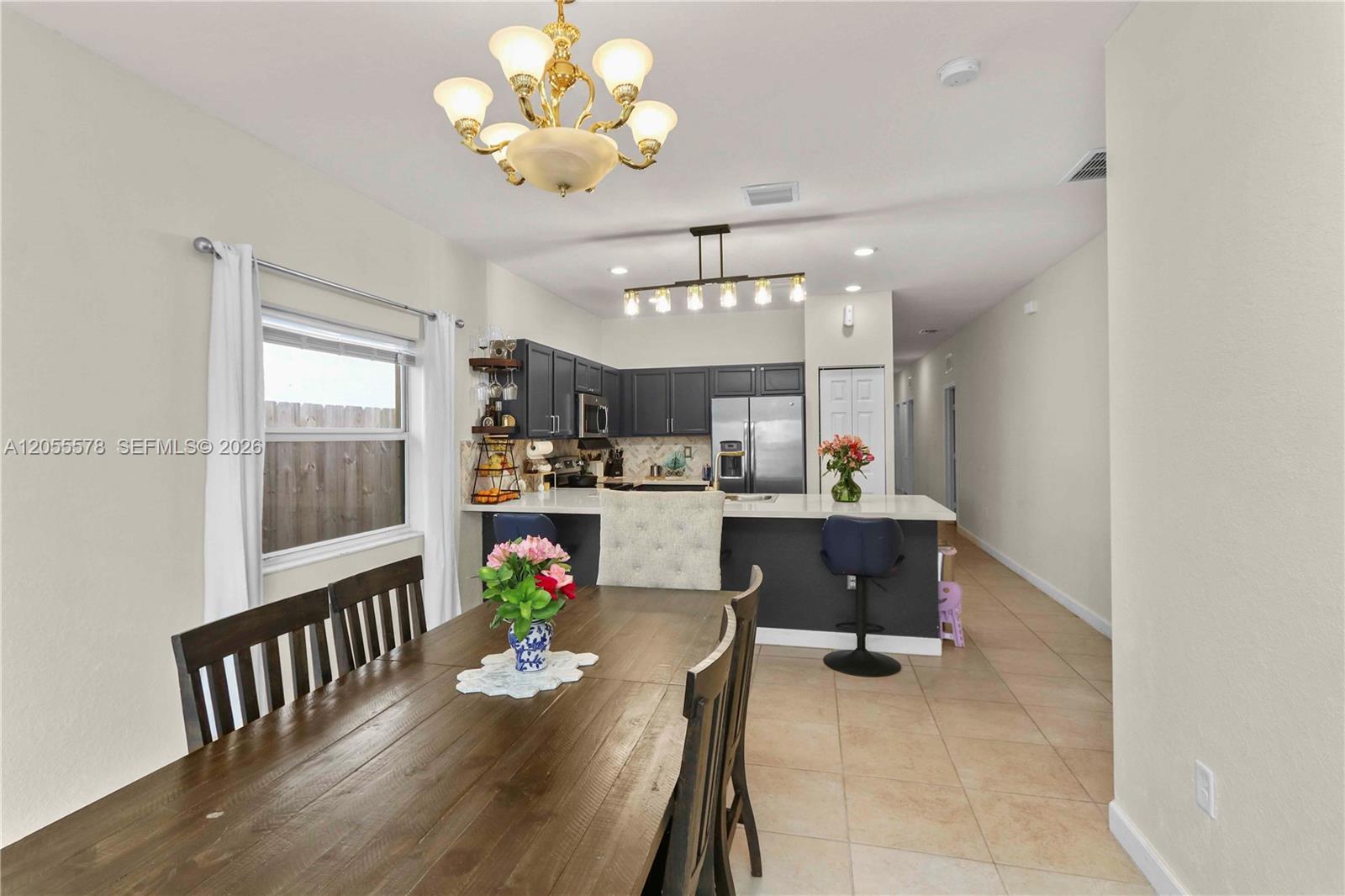 Image 3: Step into comfort! This inviting living area flows seamlessly from the entryway, creating an open an